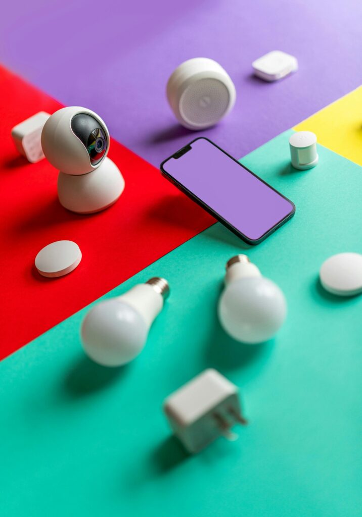 pexels-photo-16859997-16859997 Modern smart home gadgets displayed on a colorful abstract background with vibrant lighting.